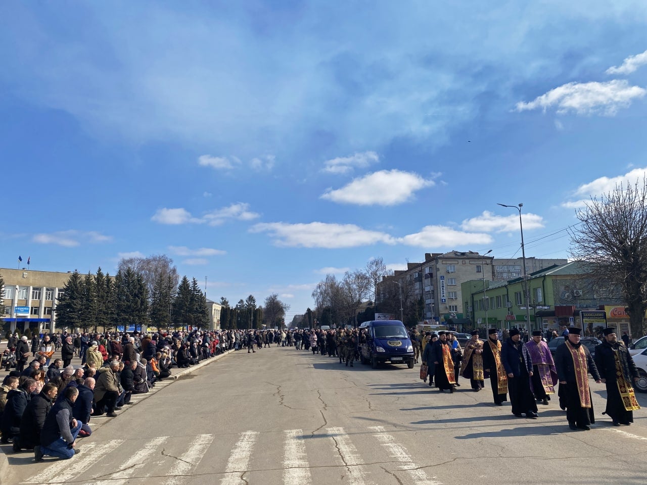 Новини Хмельницького - фото з На Хмельниччині попрощалися з трьома загиблими військовими На зображенні може бути: 9 людей, люди стоять, люди гуляють, небо та дорога